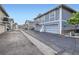 Exterior view of garages with blue siding and blacktop driveway at 13343 E Louisiana Ave, Aurora, CO 80012