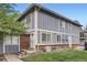 Charming exterior of a two-story townhome with a well-maintained lawn and classic architectural details at 13343 E Louisiana Ave, Aurora, CO 80012