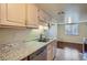 Kitchen featuring stainless steel appliances, granite countertops, and updated fixtures for modern living at 13343 E Louisiana Ave, Aurora, CO 80012