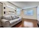 Inviting living room area featuring hardwood floors and a large window, providing ample natural light at 13343 E Louisiana Ave, Aurora, CO 80012