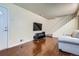 Comfortable living room with wood floors, television, and staircase at 13343 E Louisiana Ave, Aurora, CO 80012