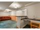 Basement with wainscotting, bar area, and bonus living space at 10732 W Florida Ave # B, Lakewood, CO 80232