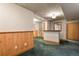 Finished basement area featuring a built-in bar with wood paneling and neutral-toned walls at 10732 W Florida Ave # B, Lakewood, CO 80232