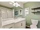 Stylish bathroom with dual sinks, white marble countertop, decorative shelves, and walk-in shower at 10732 W Florida Ave # B, Lakewood, CO 80232