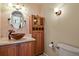 Cozy powder room featuring a copper bowl sink with granite countertops and custom wooden cabinets at 10732 W Florida Ave # B, Lakewood, CO 80232