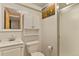 Bright bathroom features a vanity, toilet, and shower with white tiling and fixtures at 10732 W Florida Ave # B, Lakewood, CO 80232