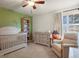 Cozy bedroom with a crib, changing table, and comfortable chair at 10732 W Florida Ave # B, Lakewood, CO 80232