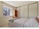 Bright bedroom featuring a large window and sliding door closet at 10732 W Florida Ave # B, Lakewood, CO 80232