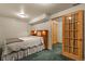 Cozy bedroom with a bed, wooden headboard, and an entrance featuring a beautiful wooden door at 10732 W Florida Ave # B, Lakewood, CO 80232