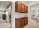 Hallway with wood cabinets and a sliding door, showcasing ample storage and neutral carpet at 10732 W Florida Ave # B, Lakewood, CO 80232
