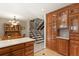 Kitchen with wood cabinets and adjoining dining area, featuring stairs in the background at 10732 W Florida Ave # B, Lakewood, CO 80232