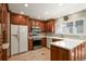 Modern kitchen with stainless steel appliances, white countertops, and cherry wood cabinets at 10732 W Florida Ave # B, Lakewood, CO 80232