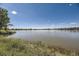 Scenic lake view with calm waters and natural vegetation at 10732 W Florida Ave # B, Lakewood, CO 80232