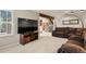 Spacious living room featuring plush carpeting, a large TV, and comfortable seating at 10732 W Florida Ave # B, Lakewood, CO 80232
