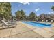 Community pool with lounge chairs, umbrellas, and a charming gazebo at 10732 W Florida Ave # B, Lakewood, CO 80232
