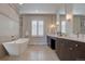 Elegant bathroom with soaking tub, double vanity, and walk-in shower at 10541 Leonardo Pl, Littleton, CO 80125