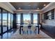 Bright dining room with a wood table and chairs, offering views and access to a deck at 10541 Leonardo Pl, Littleton, CO 80125