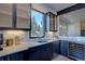 Modern kitchen features sleek cabinetry, quartz countertops, and a wine cooler at 10541 Leonardo Pl, Littleton, CO 80125