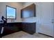 Laundry room with upper cabinets, countertop, and a door at 10541 Leonardo Pl, Littleton, CO 80125