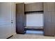 Bright laundry room with ample cabinetry and built-in bench at 10541 Leonardo Pl, Littleton, CO 80125