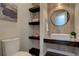 Stylish powder room with floating vanity and open shelving at 10541 Leonardo Pl, Littleton, CO 80125