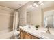 Bathroom featuring a double sink vanity, a shower-tub combination, and a bright window at 14652 Beeler St, Brighton, CO 80602