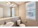 Half bath with a large mirror, commode, and modern fixtures at 14652 Beeler St, Brighton, CO 80602