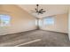 Large bedroom with carpet flooring, a ceiling fan, and plenty of natural light from the windows at 14652 Beeler St, Brighton, CO 80602