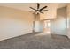Expansive bedroom featuring plush carpet, a ceiling fan, and an en-suite bathroom at 14652 Beeler St, Brighton, CO 80602
