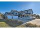 Charming two-story home with a welcoming wraparound porch and three-car garage offers ample space and curb appeal at 14652 Beeler St, Brighton, CO 80602