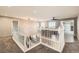 Spacious upper-level landing area with tile floors, plush carpet, and lots of natural light at 14652 Beeler St, Brighton, CO 80602