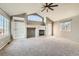 Spacious living room featuring a fireplace, built-in shelving, and large windows for ample natural light at 14652 Beeler St, Brighton, CO 80602