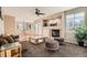 Inviting living room with a fireplace, neutral tones, access to the dining area, and sliding glass door at 14652 Beeler St, Brighton, CO 80602