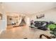 Open-concept living room flows seamlessly into the dining area with staircase, enhanced by tile and wood flooring at 14652 Beeler St, Brighton, CO 80602