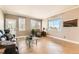 Inviting living room with tile floors, ample windows and a door offer a great view and great natural light at 14652 Beeler St, Brighton, CO 80602