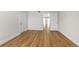 An open bedroom offers bright natural light and beautiful wood floors at 3315 S Monaco St # B, Denver, CO 80222