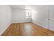Bright bedroom featuring wood floors and a large window at 3315 S Monaco St # B, Denver, CO 80222