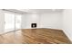 Living room showcasing hardwood floors, a fireplace and sliding glass doors at 3315 S Monaco St # B, Denver, CO 80222