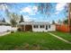 Spacious backyard with well-maintained lawn and a white fence around the perimeter at 5930 W 34Th Ave, Wheat Ridge, CO 80212