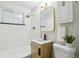 Modern bathroom with stylish tile, a vanity with a wooden cabinet, and updated fixtures at 5930 W 34Th Ave, Wheat Ridge, CO 80212