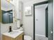 Stylish bathroom featuring modern fixtures, a framed mirror, and wainscoting detail at 5930 W 34Th Ave, Wheat Ridge, CO 80212
