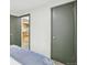 Bedroom with neutral paint, carpet, and view of the kitchen through open doorway at 5930 W 34Th Ave, Wheat Ridge, CO 80212