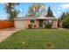 Charming brick home with a well-manicured lawn and mature trees at 5930 W 34Th Ave, Wheat Ridge, CO 80212
