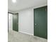 Hallway featuring neutral paint and carpet, and dark green painted doors at 5930 W 34Th Ave, Wheat Ridge, CO 80212