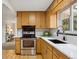 Bright kitchen with stainless steel appliances, custom cabinets, and tiled backsplash at 5930 W 34Th Ave, Wheat Ridge, CO 80212