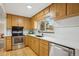 Well-lit kitchen featuring wooden cabinets and stainless steel appliances at 5930 W 34Th Ave, Wheat Ridge, CO 80212