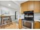 Kitchen with stainless steel appliances and breakfast bar seating at 5930 W 34Th Ave, Wheat Ridge, CO 80212