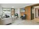 Well-lit living room with brick accents, comfortable seating, and a neutral color palette at 5930 W 34Th Ave, Wheat Ridge, CO 80212