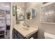 Bathroom featuring a single sink vanity, updated mirror, and modern accents at 2890 W Long Cir # A, Littleton, CO 80120
