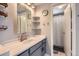 Bathroom featuring a single sink vanity, updated fixtures, and shelving at 2890 W Long Cir # A, Littleton, CO 80120